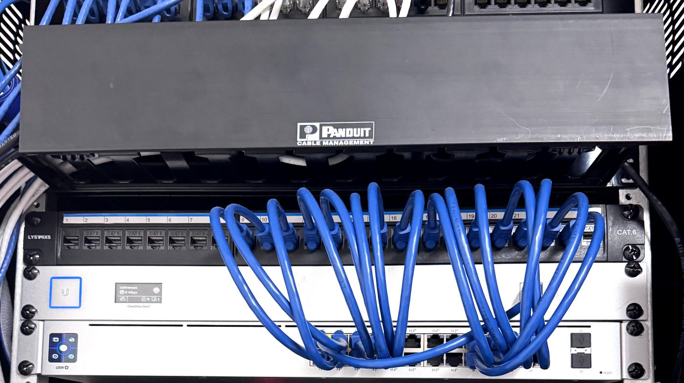 Cat6 patch panel, cable management and network switch in a rack installed by Allied Technologies