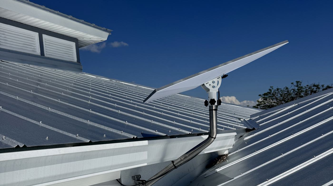 Starlink dish mounted on a standing-seam metal roof with a weatherproof cable entry, installed by Allied Technologies