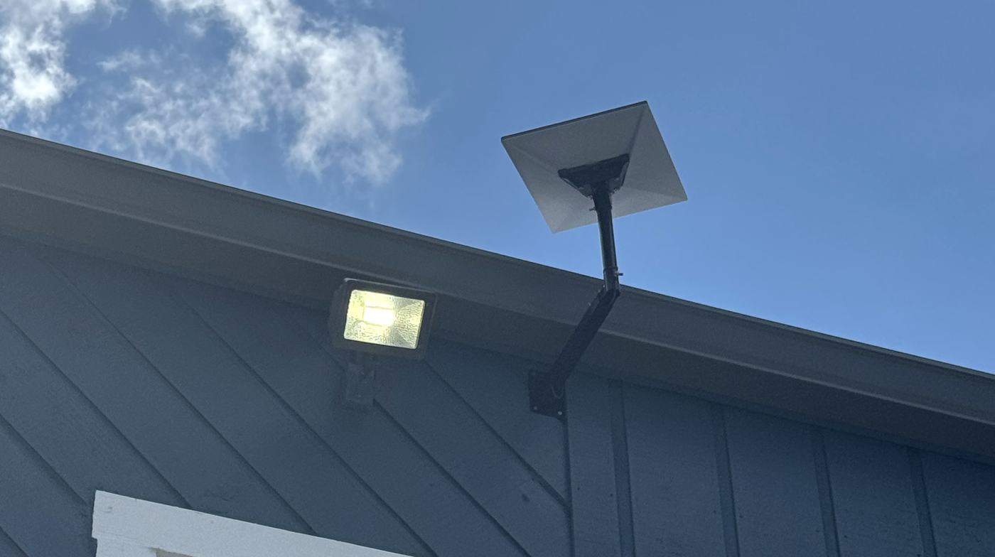 Starlink dish on a heavy-duty wall standoff bracket above a commercial roofline, installed by Allied Technologies